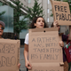 Protesters, with slogans written on pizza delivery boxes, demonstrate outside Federal Court on July 24 in New York